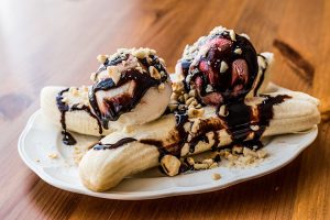 Banana Split With Ice Cream, Chocolate Sauce And Hazelnuts..